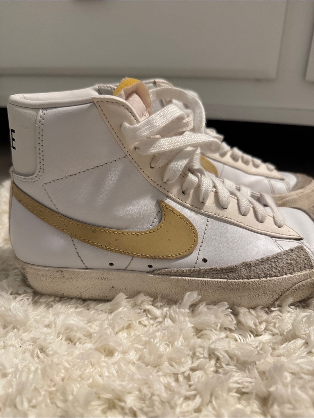 Nike Kids White High-Top Sneakers with Gold Swoosh Accent